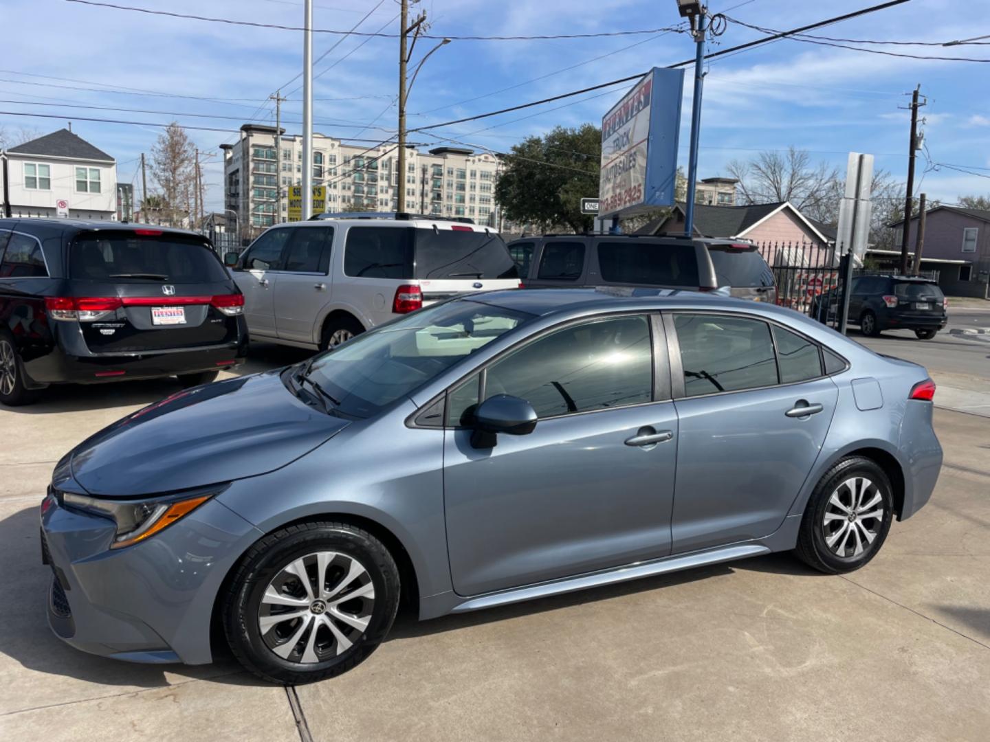 2022 Blue /Silver Toyota Corolla LE (JTDEAMDEXNJ) with an 1.8L Hybrid engine, Automatic transmission, located at 1501 West 15th St., Houston, 77008, (713) 869-2925, 29.797941, -95.411789 - Photo#0